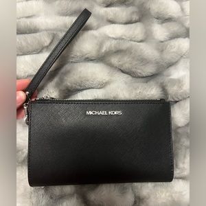 Black saffiano leather Michel Kors wallet wristlet.